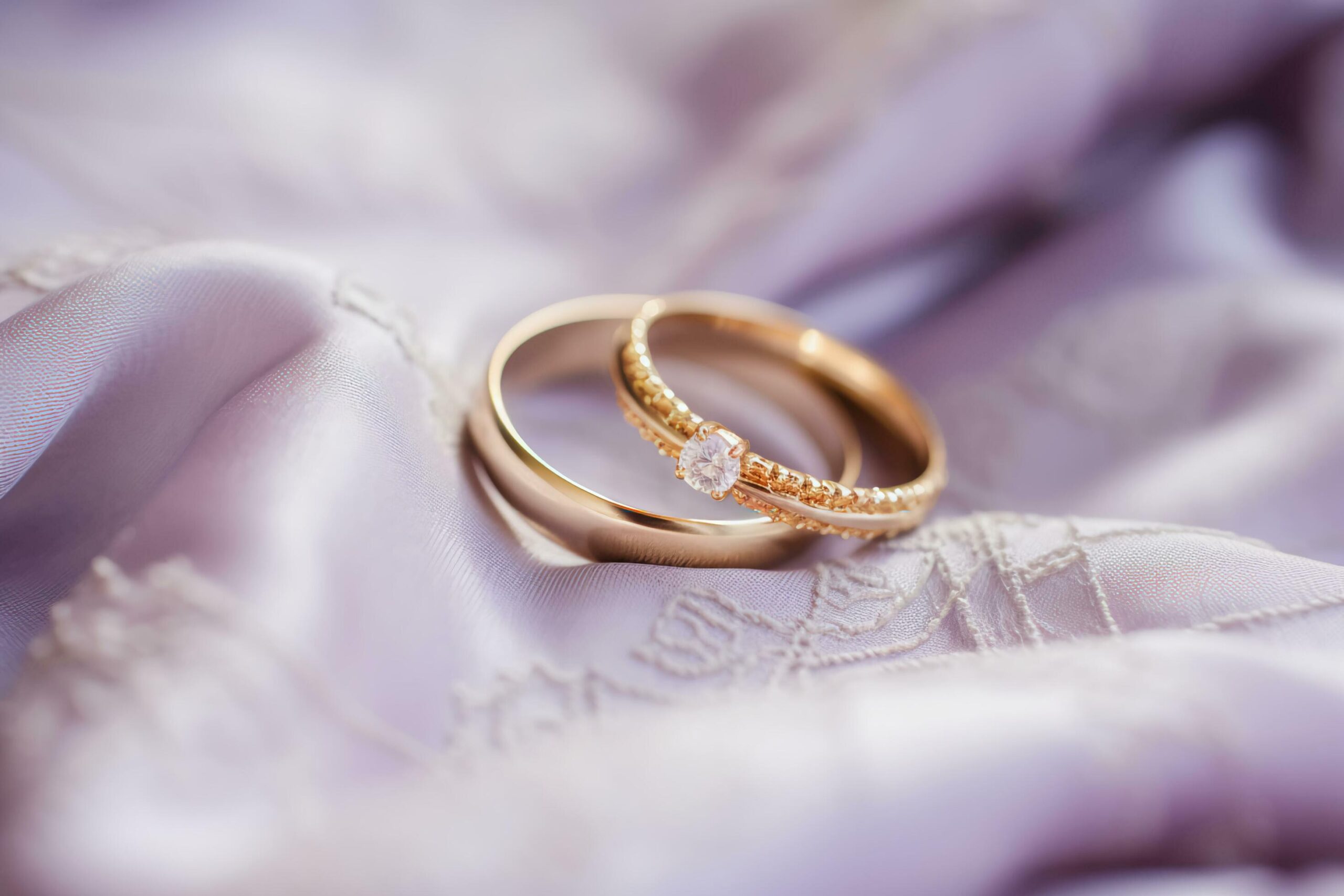 Ai-generated-lilac-love-wedding-rings-resting-on-soft-fabric-free-photo