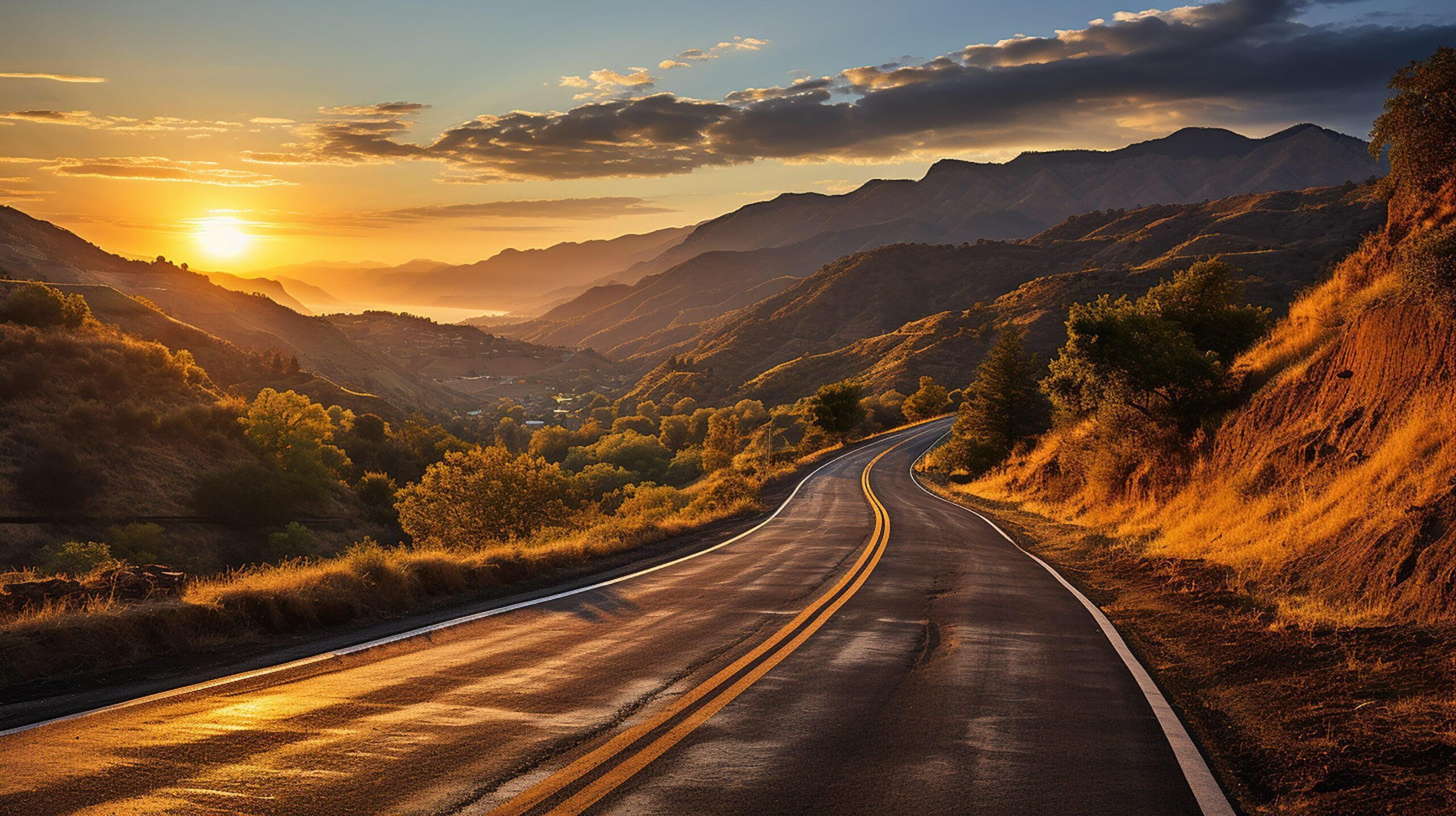 Ai-generated-scenic-curved-highway-asphalt-road-with-golden-sky-and-mountain-in-the-sunset-free-photo