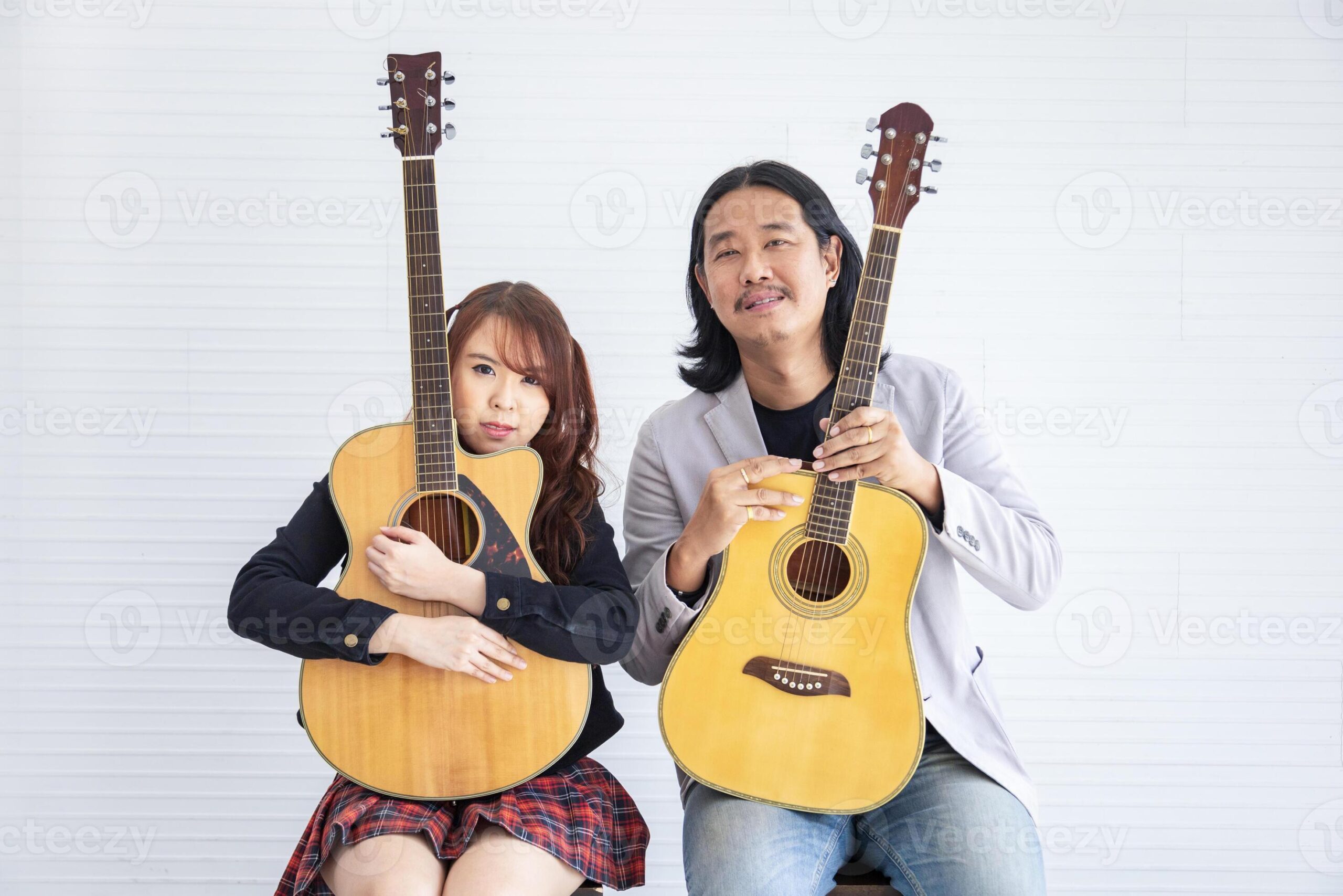 Portrait-of-asian-family-duo-band-with-two-guitarist-of-father-and-daughter-on-white-background-for-music-artist-musician-style-concept-photo