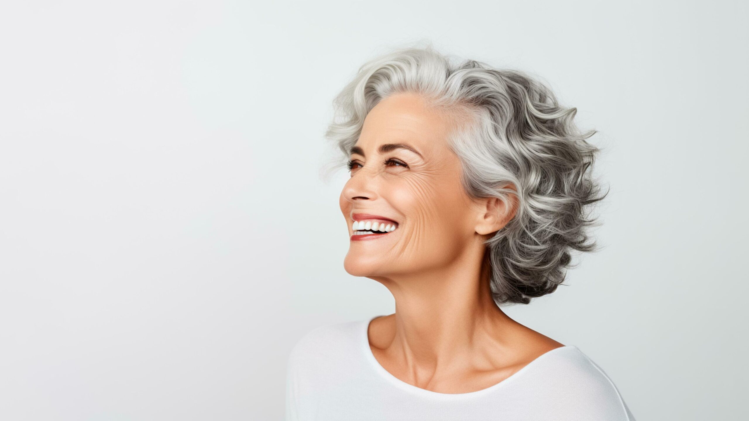 Ai-generated-50s-middle-aged-elderly-senior-model-woman-with-grey-hair-smiling-white-background-ai-generated-free-photo