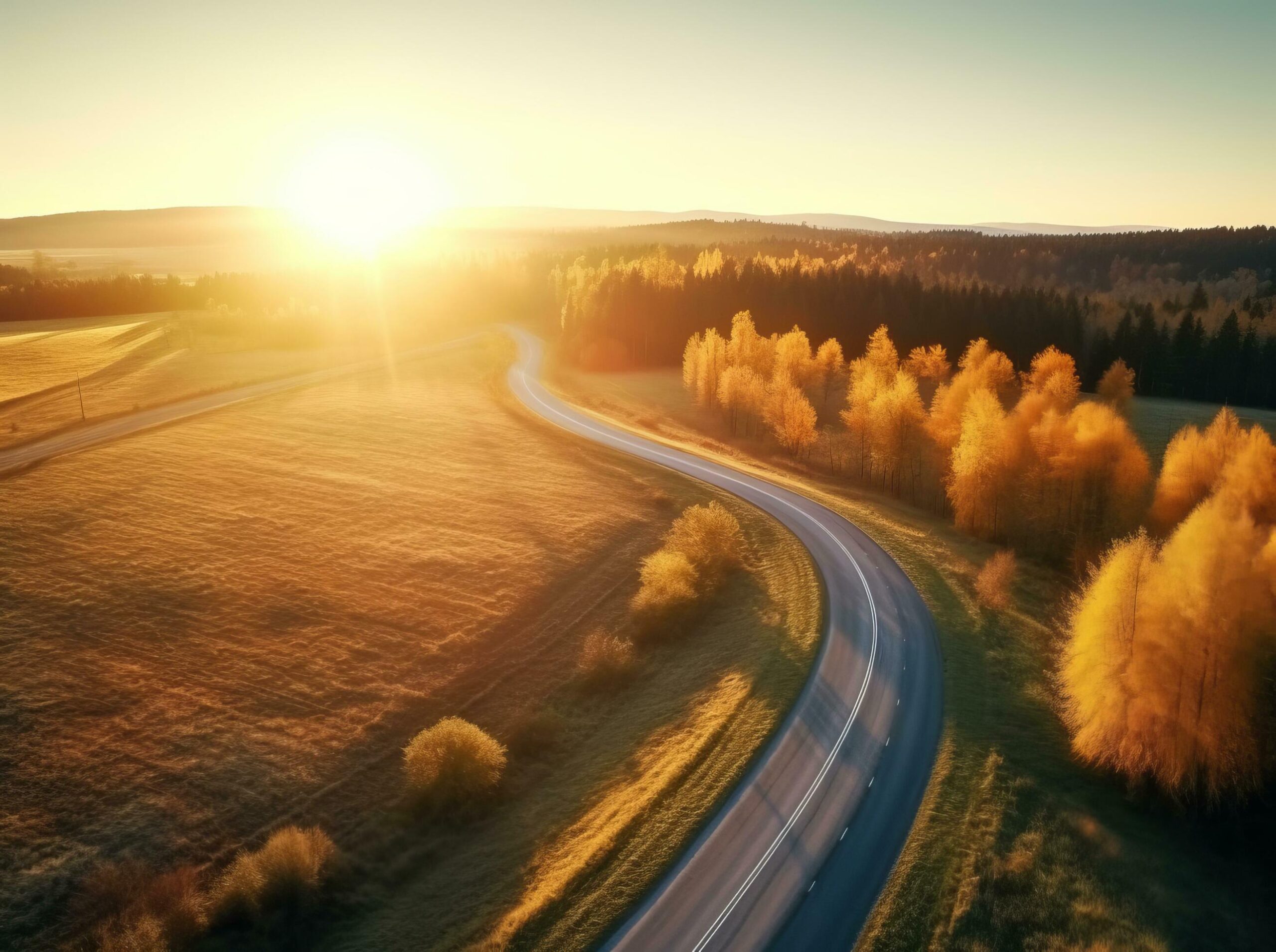 Ai-generated-aerial-view-of-mountain-road-in-forest-at-sunset-in-autumn-free-photo