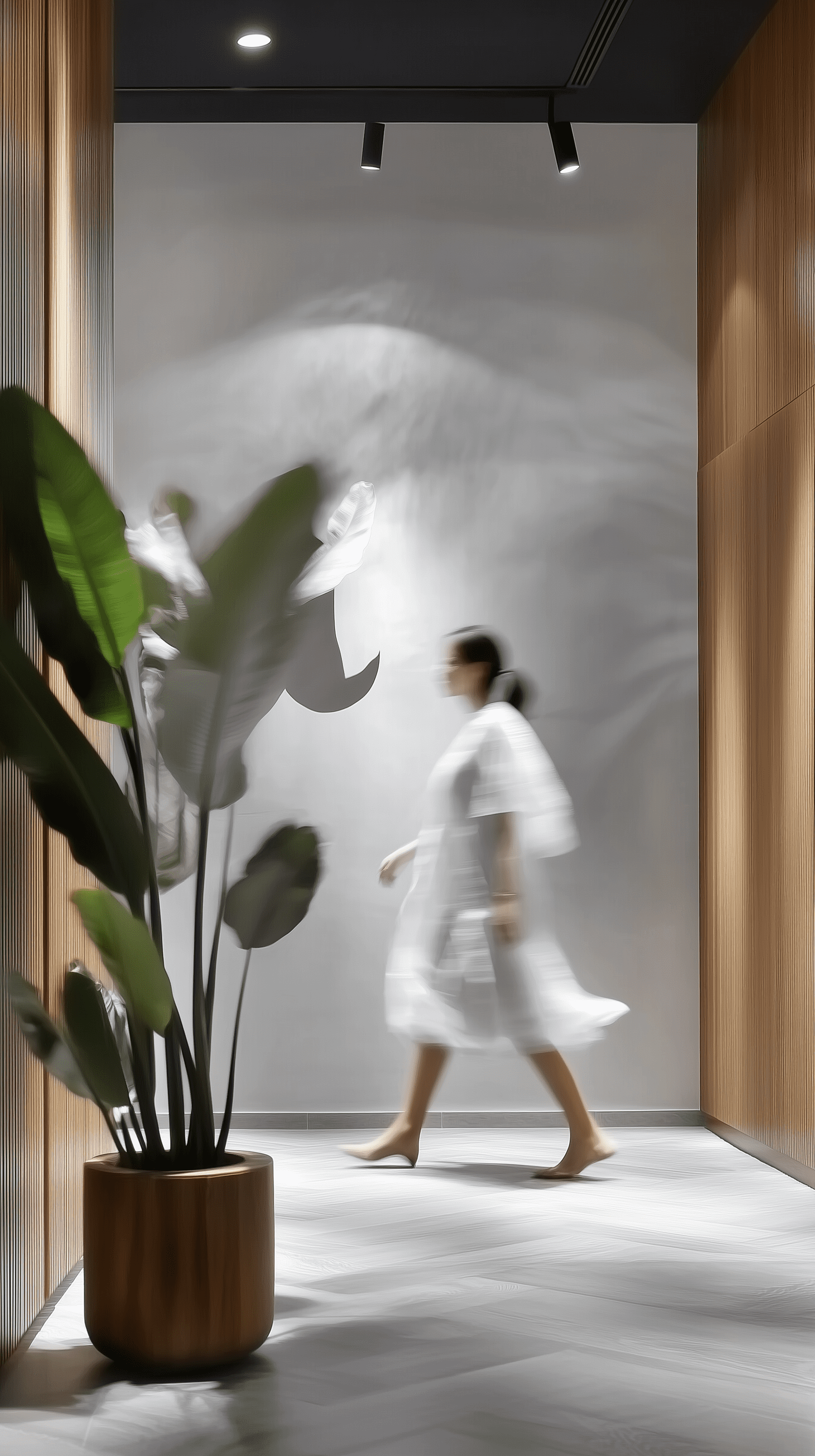 Minimalist interior scene with soft, natural lighting, featuring a modern office space with clean, wooden panel walls, a potted plant with tall, thin leaves stands in the foreground, adding a touch of greenery to the otherwise neutral tones, a blurred figure dressed in white walks past, creating a sense of movement and calmness in the serene environment, neutral color palette, soft shadows, clean lines, modern aesthetic --ar 9:16 --style raw --sref 3678596090 --v 6. 1